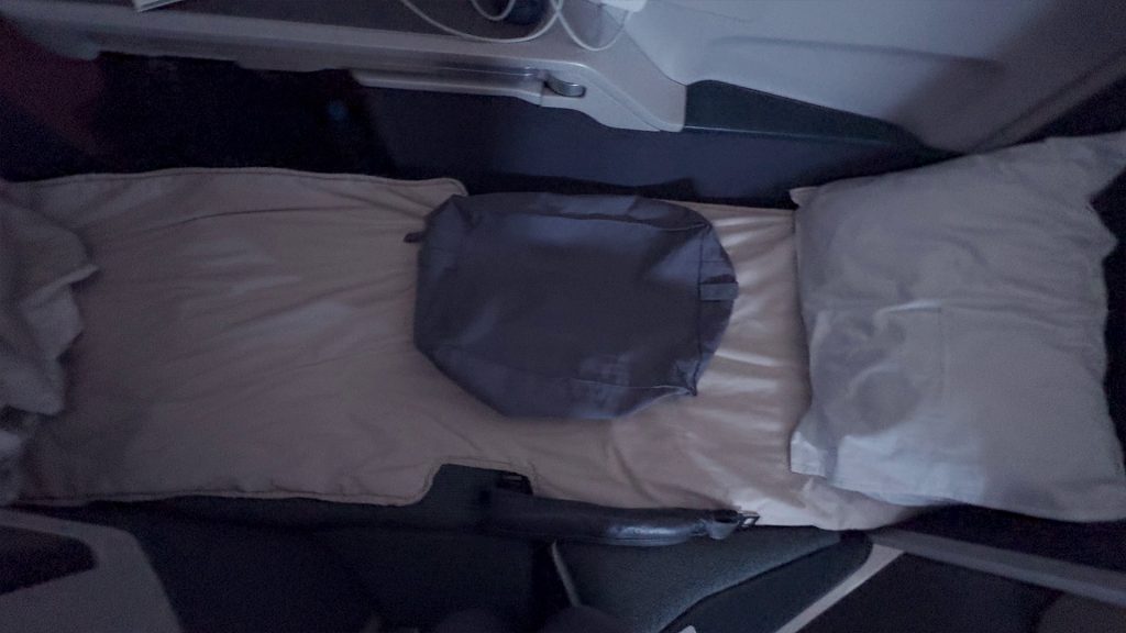 Cathay Pacific 777-300ER business class lie-flat bed in fully reclined position